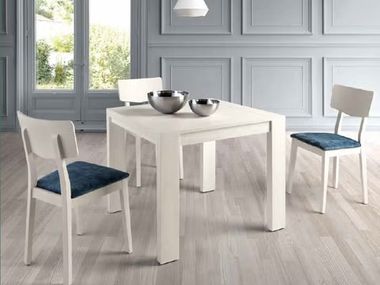 mesa de comedor blanca y sillas blancas y asiento azul