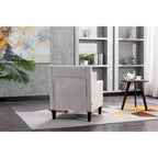 Sillón de tela de lino con detalles de tachuelas y patas de madera maciza