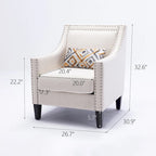 Sillón de tela de lino con detalles de tachuelas y patas de madera maciza
